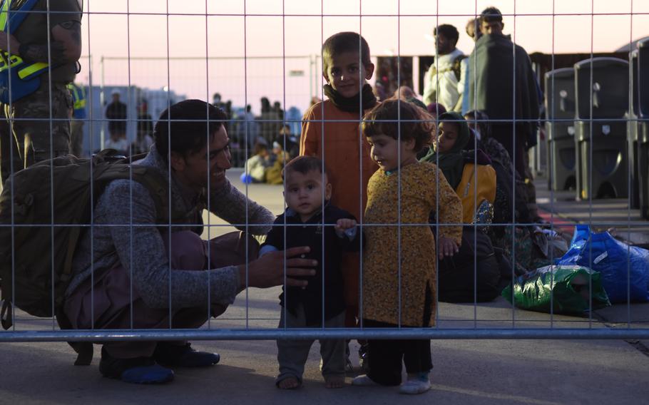 An Afghan family prepares with others to depart Ramstein Air Base, Germany, Sept. 2, 2021. So far more than 22,000 evacuees from Afghanistan have flown through Ramstein to the United States or other destinations.