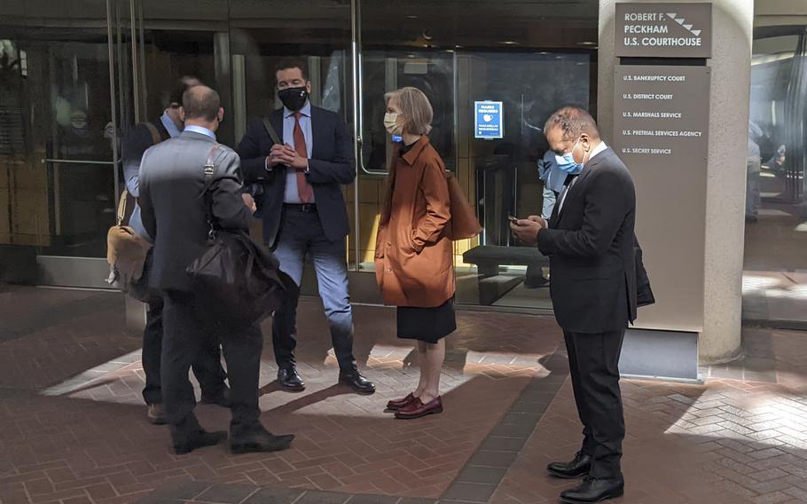 Former Theranos executive Ramesh "Sunny" Balwani, right, stands near his legal team outside Robert F. Peckham U.S. Courthouse in San Jose, Calif., on March 1, 2022. A jury on Tuesday, June 21 is scheduled to hear closing arguments in the trial of Balwani, the former Theranos officer charged with teaming up with his secret lover, CEO Elizabeth Holmes, to carry out a massive fraud.