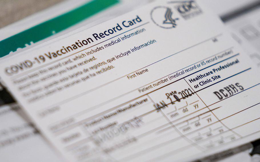 Vaccination record cards sit ready at a station at the Dallas County  COVID-19 mega-vaccination site at Fair Park, Texas, on Friday, Jan. 22, 2021, in Dallas.