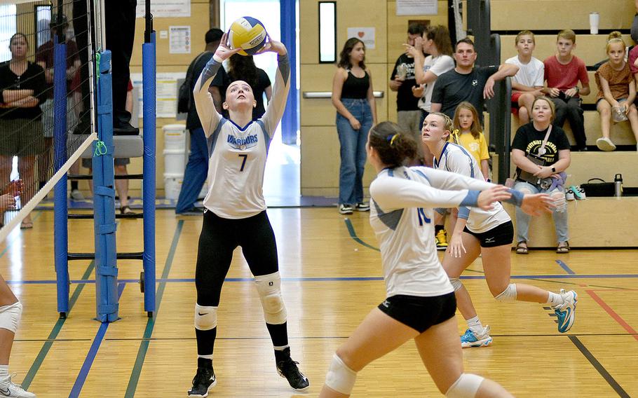 Wiesbaden's Audrey Garrison sets the ball while teammate Hannah Buchheit heads toward the net in a match against Sttutgart on Sept. 9, 2023, at Wiesbaden High School in Wiesbaden, Germany.