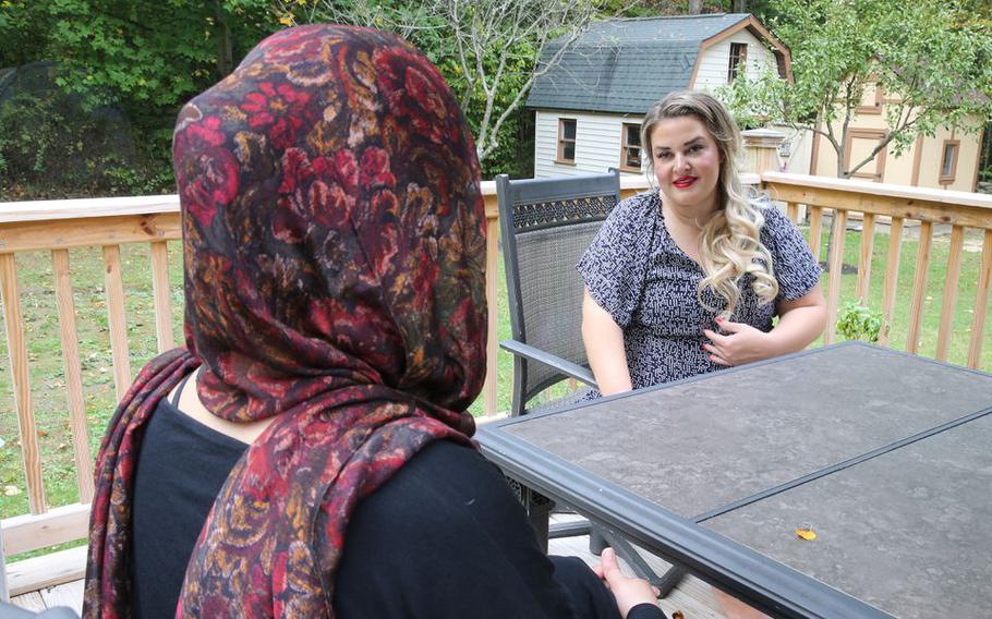 Lorain County native Jane Horton, a former senior Department of Defense official and Gold Star wife whose husband, U.S. Army Specialist Christopher Horton, was killed in Afghanistan in 2011, has a conversation with an Afghan refugee living in their home, October 14, 2021.
