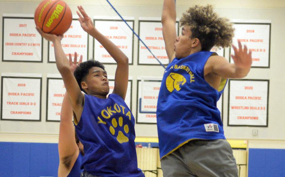 Yokota's Eian Flowers goes up to shoot against teammate Braden Raybon.