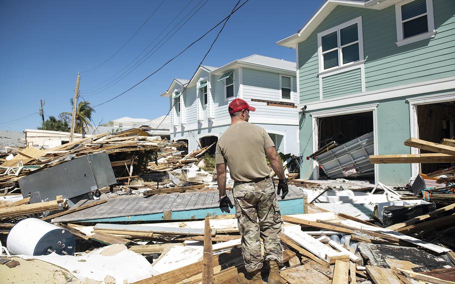 Members of the 202nd Red Horse Squadron clear roads in Fort Myers Beach, Florida, in response to Hurricane Ian on Friday, Sept. 30, 2022.