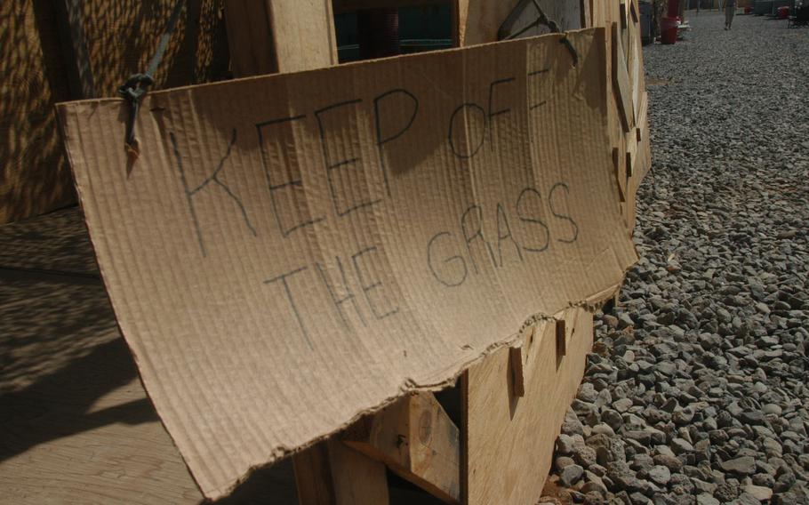 A humorous sign outside one tent at Camp Lemonier warns people to keep off the non-existent grass. The only green things found on the 88-acre compound are tents.