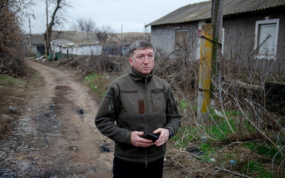 Volodymyr Vesyolkin, the military civil administration head, stands on a Hranitne street, which was damaged after shelling in October.