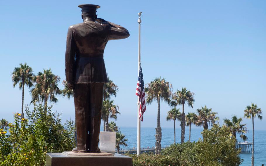 In this July 31, 2020, photo, the U.S. flag is seen lowered to half-staff at Park Semper Fi in San Clemente, Calif., after a seafaring assault vehicle sank off the coast of Southern California. 