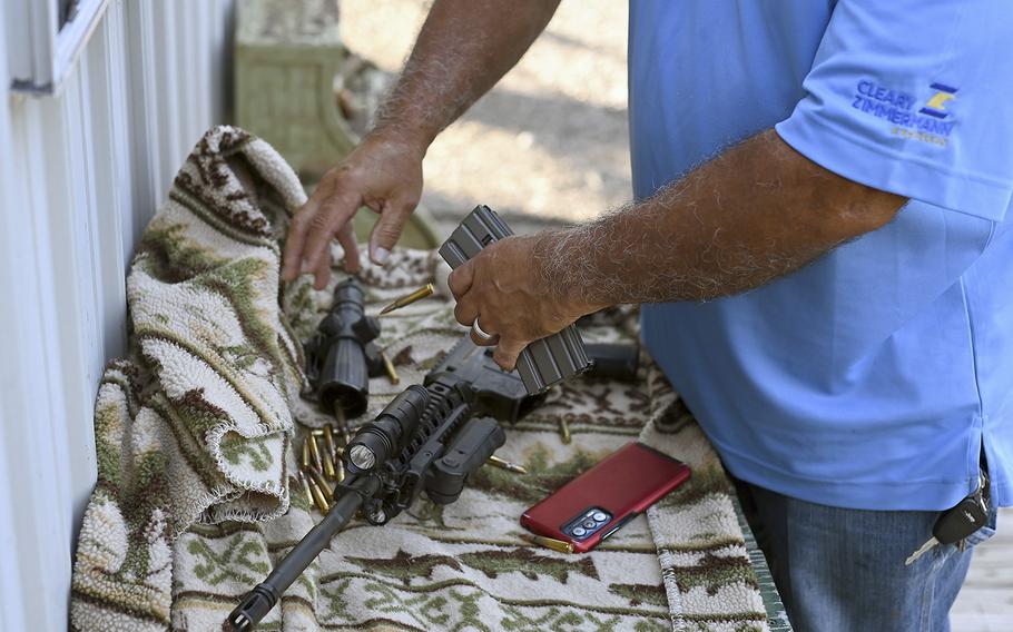 Bullets are removed from a clip to an AR-15. 