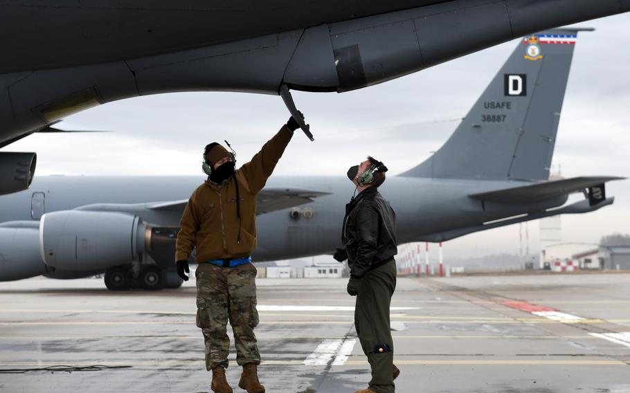 Maj. Grant Starkweather, right, a 351st Air Refueling Squadron pilot, does a preflight check on a KC-135 Stratotanker aircraft with Staff Sgt. Benjamin Kellum in Lithuania, in March 2021. A Chicago Council poll has found that 65% of Americans polled support long-term bases in the Baltic states of Latvia, Lithuania or Estonia.