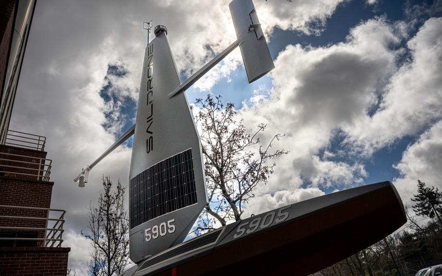 A metallic sail on top of a metallic boat, both with black sensors on them.
