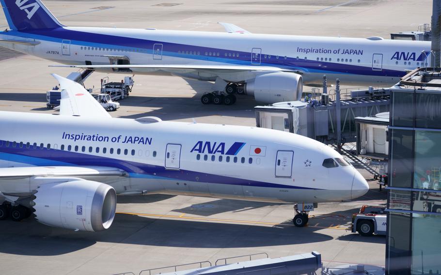 All Nippon Airways airliners prepare for departures from gates at Haneda International Airport, Japan, on Nov. 10, 2021.
