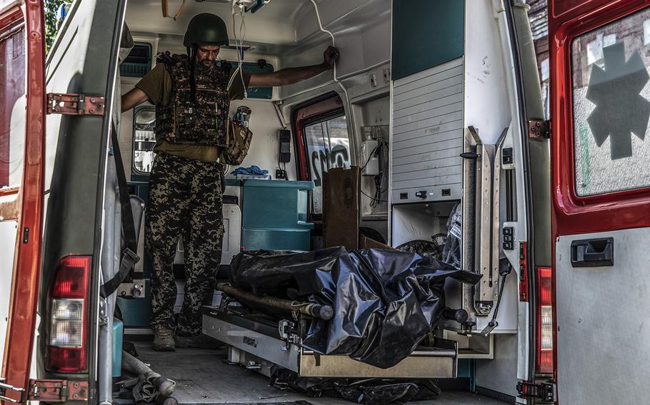 A medic stands in an ambulance that has arrived in Bakhmut with the body of a 25-year-old Ukrainian soldier killed by Russian forces. 