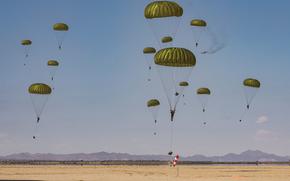Paratroopers with the 19th Special Forces Group (Airborne), 9th Psychological Operations Battalion, Utah National Guard and Moroccan armed forces land in a drop zone near Ben Guerir, Morocco, during exercise African Lion on May 20, 2024.