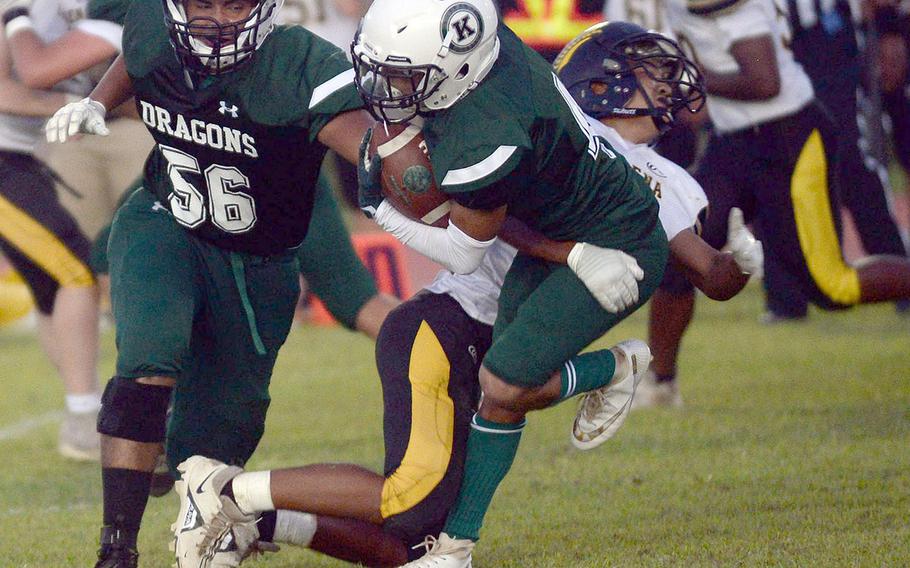 Kubasaki running back Abriel Mata gets hauled down by Kadena's Jake Mariano.