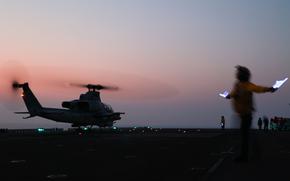 Sailors assigned to amphibious assault ship USS Bataan prepare a Marine Corps UH-1Y Venom helicopter to take off in the Persian Gulf on Sept. 5, 2023. An AH-1Z Viper attack helicopter assigned to the 26th Marine Expeditionary Unit had a laser directed at it by Iranian forces as it flew in international airspace in the Gulf, the Navy said Sept. 28.
