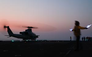 Sailors assigned to amphibious assault ship USS Bataan prepare a Marine Corps UH-1Y Venom helicopter to take off in the Persian Gulf on Sept. 5, 2023. An AH-1Z Viper attack helicopter assigned to the 26th Marine Expeditionary Unit had a laser directed at it by Iranian forces as it flew in international airspace in the Gulf, the Navy said Sept. 28.