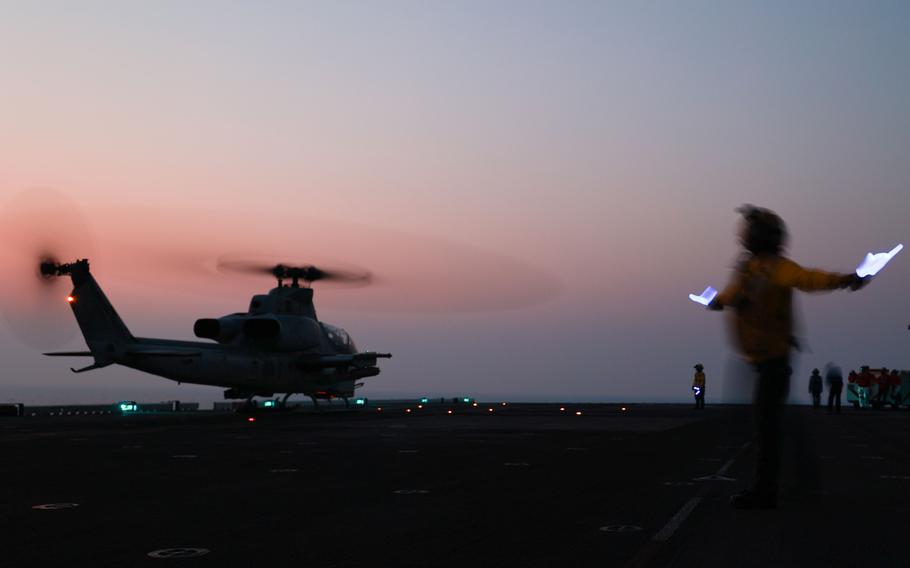 Sailors assigned to amphibious assault ship USS Bataan prepare a Marine Corps UH-1Y Venom helicopter to take off in the Persian Gulf on Sept. 5, 2023. An AH-1Z Viper attack helicopter assigned to the 26th Marine Expeditionary Unit had a laser directed at it by Iranian forces as it flew in international airspace in the Gulf, the Navy said Sept. 28.