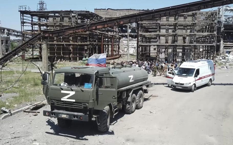 In this photo taken from video released by the Russian Defense Ministry on Monday, June 13, 2022, a Russian military vehicle stands next to the Metallurgical Combine Azovstal plant in Mariupol, on territory under the control of the Donetsk People’s Republic in eastern Ukraine. The plant was almost completely destroyed during the siege of Mariupol.