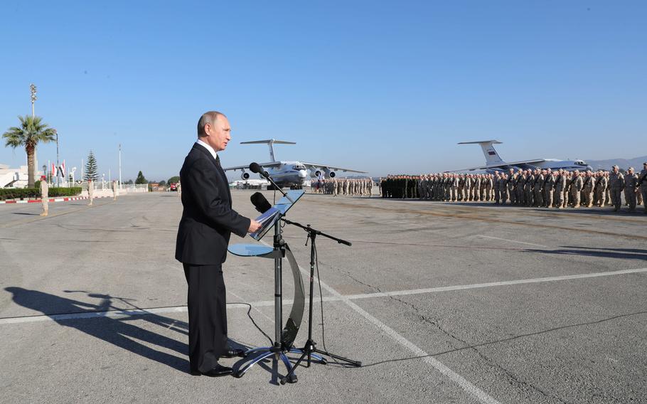 Russian President Vladimir Putin addresses the troops at the Hemeimeem air base in Syria, Dec. 11, 2017. 