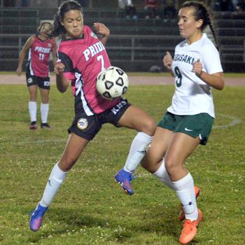 Kadena's Mia Garza and Kubasaki's Ally Garcia go up for the ball during Wednesday's Okinawa girls soccer match. The Panthers won 3-2.