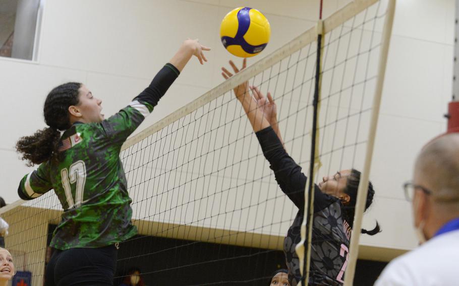 Kubasaki’s Olivia Schaffeld and Nile C. Kinnick’s Jenia Viles battle at the net for the ball.