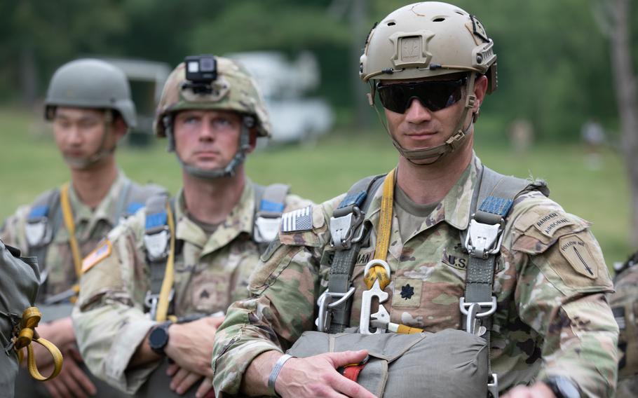 Army Lt. Col Nathan Showman and other Rangers assigned to the 5th Ranger Training Battalion wait for two UH-60 Black Hawk helicopters to land in Dahlonega, Ga., on July 14, 2023. 