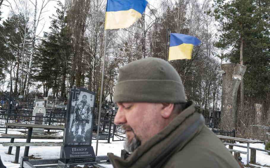 Kholodov prays at the graves of two men who were killed fighting in the ongoing conflict with Russian-backed separatists in eastern Ukraine.