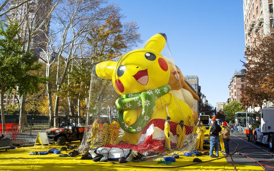 Crews pump helium into a balloon of Pikachu and Eevee in New York on Wednesday, Nov. 24, 2021, as the balloon is readied for the Macy’s Thanksgiving Day Parade on Thursday.
