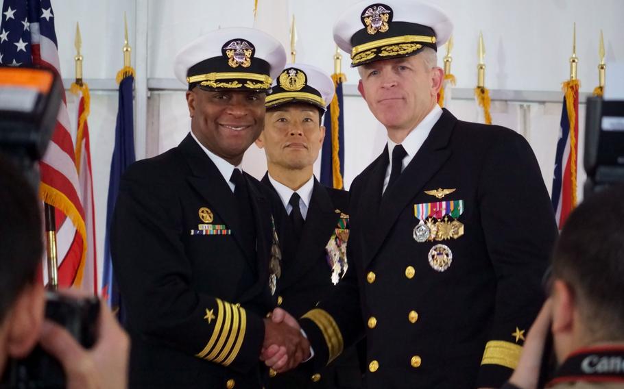 Capt. Walter Mainor, left, outgoing commander of Destroyer Squadron 15, shakes hands with Rear Adm. Pat Hannifin, commander of Task Force 70, during a change of command ceremony at Yokosuka Naval Base, Japan, on Nov. 17, 2023. 