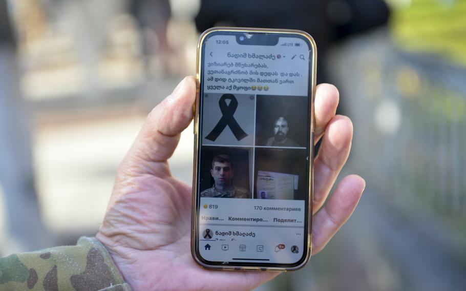 Nadim Khmaladze, a Georgian and a foreign fighter in the Ukrainian military, shows a Facebook page memorializing the death of Gurgen Gagnidze, another soldier from Georgia who had volunteered to fight in Ukraine against Russian forces. Gagnidze’s funeral drew a crowd of about 40 soldiers from both Ukraine and Georgia, as well as civilians, to St. Volodymyr’s Cathedral in Kyiv, Ukraine on Nov. 1, 2022. 