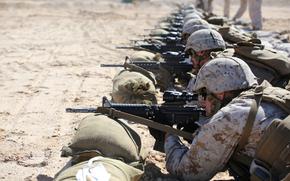 Marines with Company A, Ground Combat Element Integrated Task Force, fire the M4 Modular Weapon System during a zeroing exercise at Range 106, Marine Corps Air Ground Combat Center Twentynine Palms, California, Feb. 24, 2015. From October 2014 to July 2015, the GCEITF will conduct individual and collective level skills training in designated ground combat arms occupational specialties in order to facilitate the standards-based assessment of the physical performance of Marines in a simulated operating environment performing specific ground combat arms tasks. (U.S. Marine Corps photo by Sgt. Alicia R. Leaders/Released)