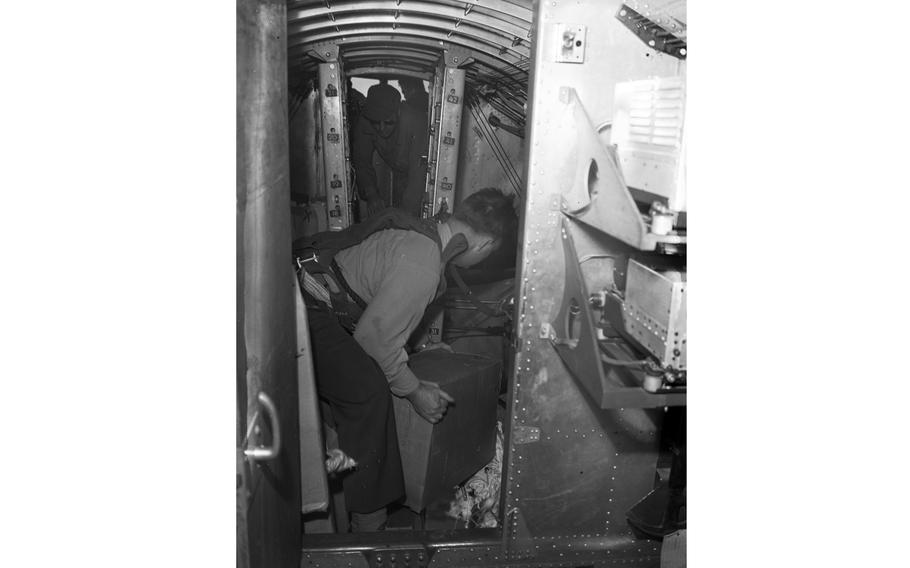 Capt. Eugene T. Williams, U.S. Air Force assistant German Youth Activities officer, throws candy out of the Bon Bon Bomber.