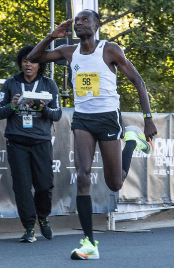 Makorobondo Salukombo salutes as he crosses the finish line as runner-up in the men’s division of the Army 10-Miler on Sunday, Oct. 9, 2022, at the Pentagon.