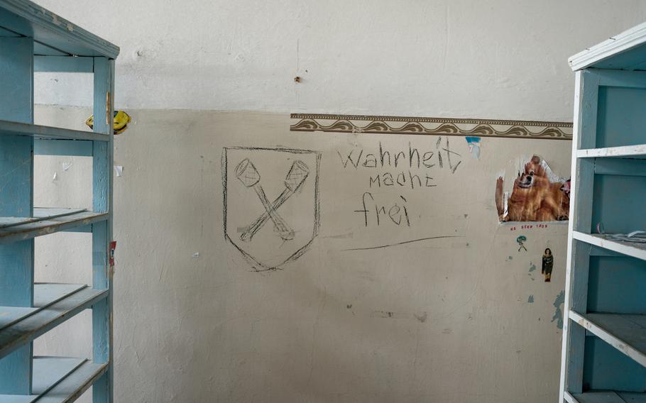 “Truth sets you free” is written in German on the wall of the one of the rooms at a medical clinic that occupying Russian forces used as a detention center and torture site in Izyum, Ukraine.