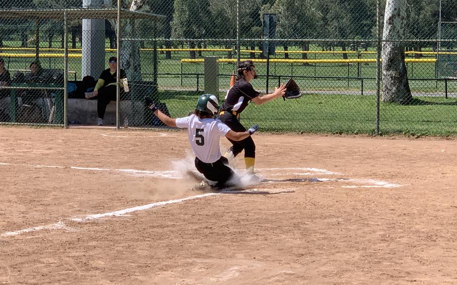 Naples junior Kennedy Rascoe slides home after the ball went to the backstop on Saturday, April 30, 2022 in the Wildcats' 12-1 victory over Vicenza.