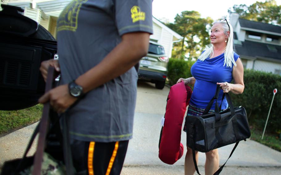 Deb Coon, who fostered Nipsey while Myesha Harris was on her fourth deployment, helps pack up the dog's belongings on Oct. 14, 2022.