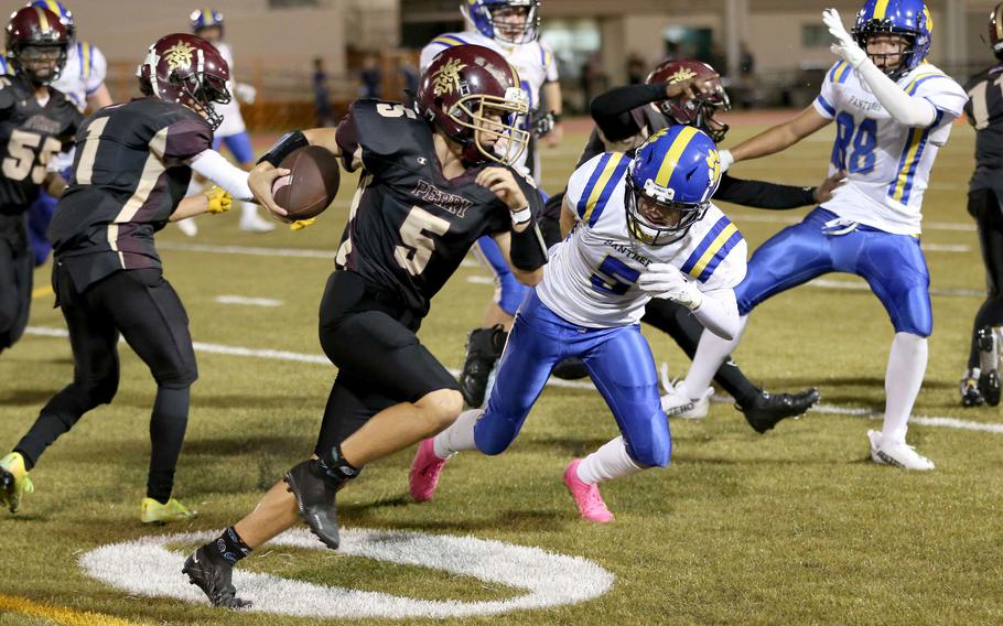 Matthew C. Perry's Shayden Torres tries to run past Yokota's Rodrigo Negron-Blanco.