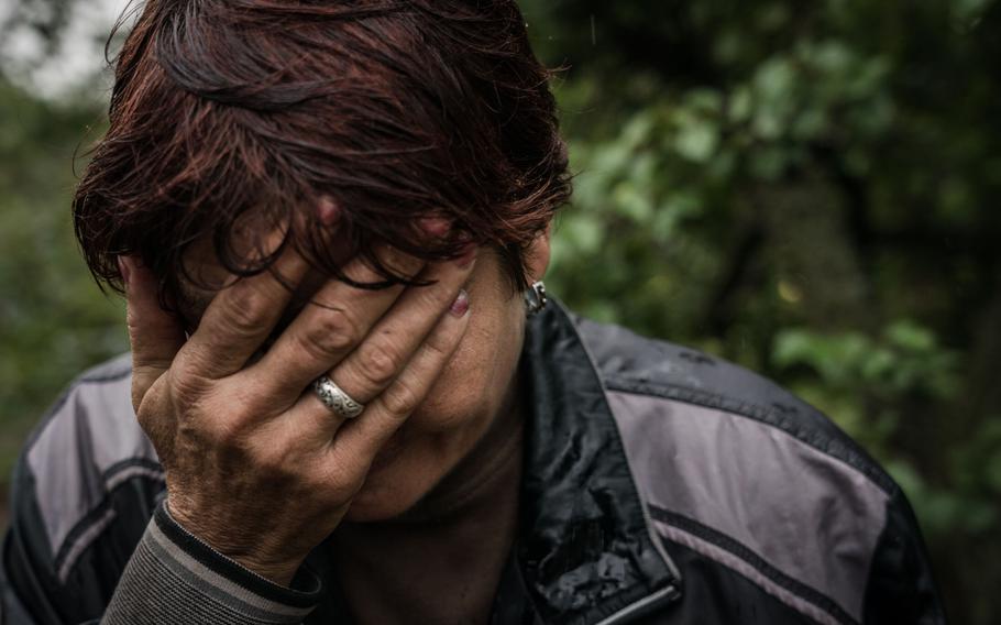 A woman cries as she recounts what Russian soldiers did to residents of Izyum during their occupation of the city.