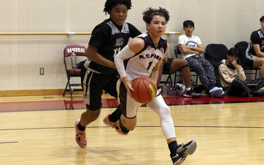 Matthew C. Perry's Shayden Torres drives to the basket ahead of Zama's Casey Stewart during Friday's DODEA-Japan boys basketball game. The Samurai won 58-44.