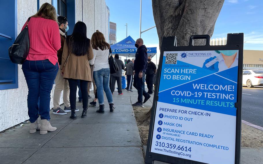 People line up at a COVID-19 testing tent at the corner of Third Street and Fairfax Boulevard, in Los Angeles, Jan. 3, 2022. 