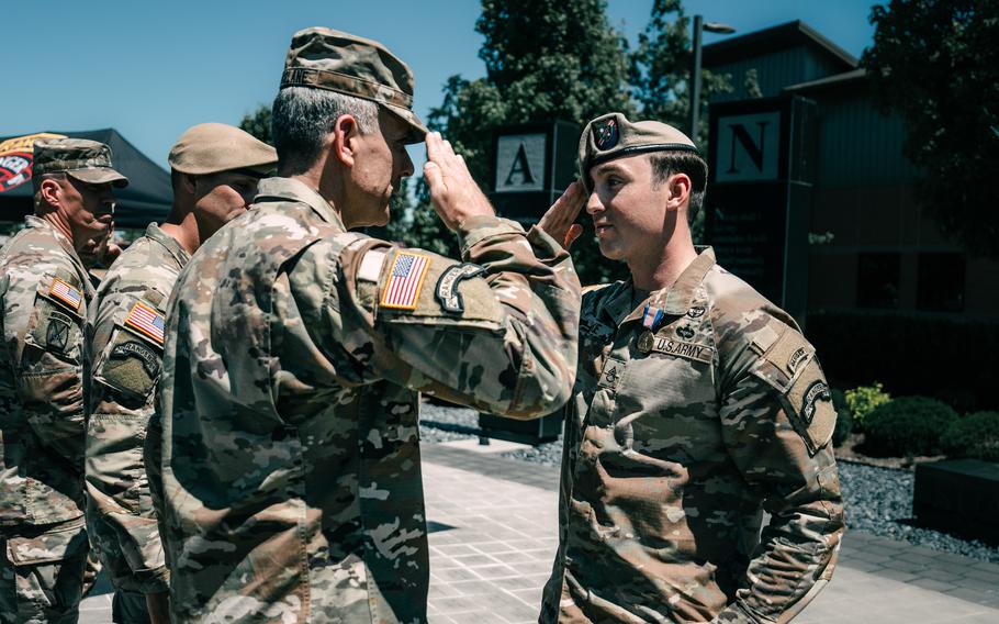 Two soldiers saluting each other.