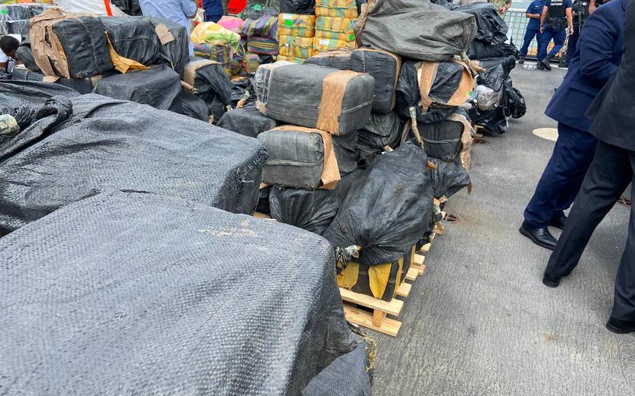 Packages of cocaine and marijuana are stacked on the deck of the U.S. Coast Guard Cutter James Thursday, Feb. 17, 2022.