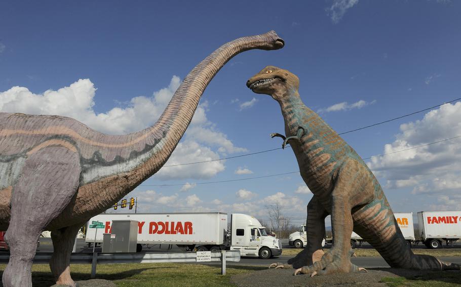 Trucks pass by Dinosaur Land on Route 340 in White Post, Va. 