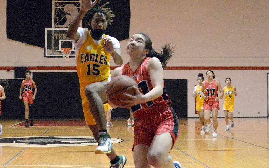 Nile C. Kinnick's Jasmine Pho ldrives for a shot past Robert D. Edgren's Jaylie Johnson during Friday's semifinal in the DODEA-Japan girls basketball tournament. The Red Devils won 53-10 and will face E.J. King in Saturday's final.