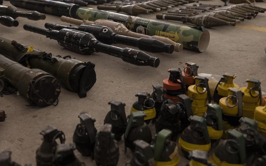 Captured Hamas weapons, including hand grenades and rocket-propelled grenades, are displayed during a news conference for foreign media at a military base in southern Israel on Oct. 20.