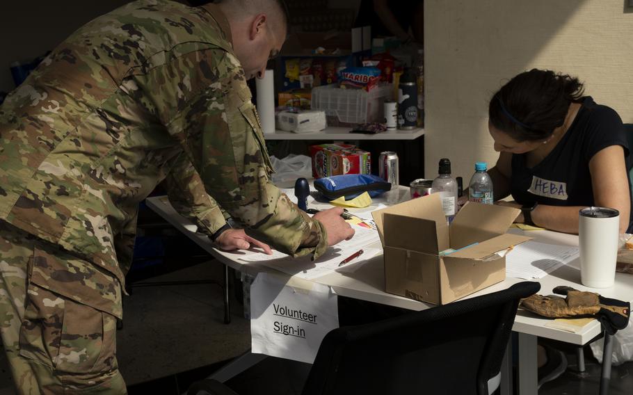 A military volunteer signs up to help with relief efforts for Afghan refugees at Ramstein Air Base on Aug. 26, 2021. 