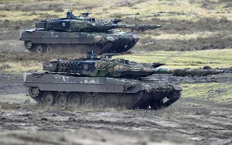 Two Leopard 2 tanks take part in a demonstration in Augustdorf, Germany, on Feb. 1, 2023. German officials reached out to Swiss authorities in February seeking the re-sale of 25 out-of-service tanks, which would be kept in Germany or among NATO or EU partners to complement their arsenals. Germany has delivered 18 of its Leopard 2A6 tanks to Ukraine.