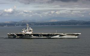 In this handout released by the U.S. Navy, The aircraft carrier USS Theodore Roosevelt (CVN 71) leaves its San Diego homeport in 2020. 