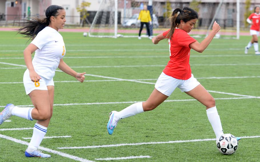 E.J. King's Jemalyn Nocon outruns Yokota's Yesi Hutton to the ball during Saturday's DODEA-Japan girls soccer match. The Panthers won 1-0.
