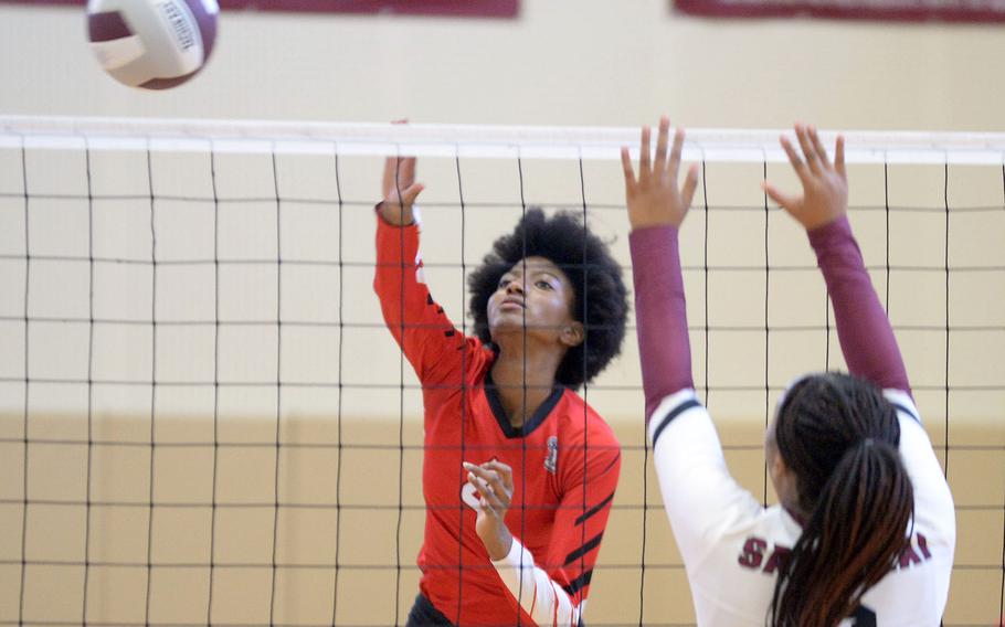 E.J. King's Liz Turner spikes past Matthew C. Perry's Aisha Watley during Saturday's DODEA-Japan volleyball match. The Cobras won 25-10, 25-15, 25-13, hours after also beating the Samurai 25-7, 25-10, 25-7 on Friday.
