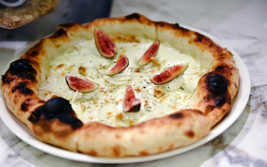 A white pizza sits on a counter